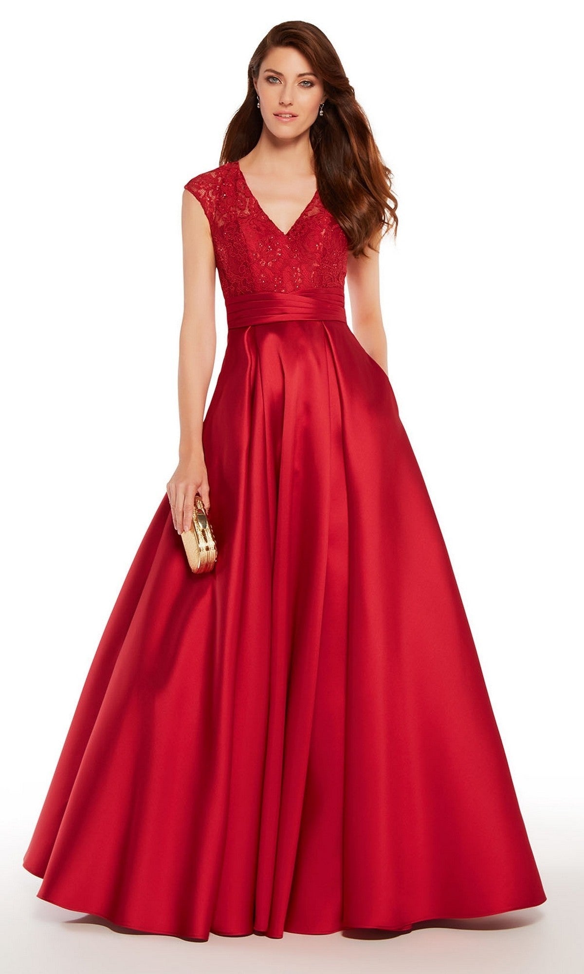A woman in the Long Formal Dress: Alyce 27278, a crimson satin gown with a beaded lace bodice and A-line skirt, holds a small gold clutch while standing against a plain white background.